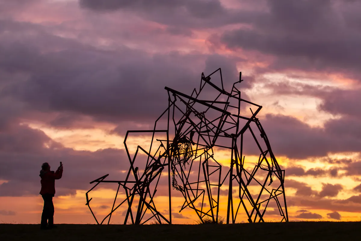 An outdoor sculpture beside a coastal walking path