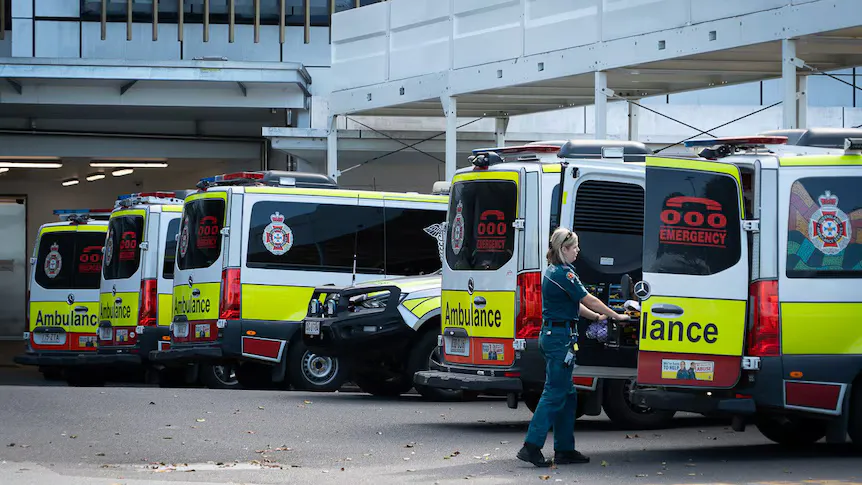 Ambulances parked near a hospital emergency department