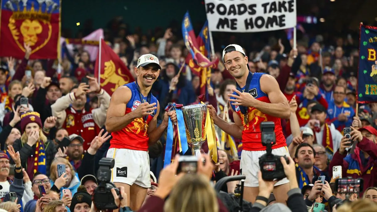 Australian rules football goalposts under stadium lights