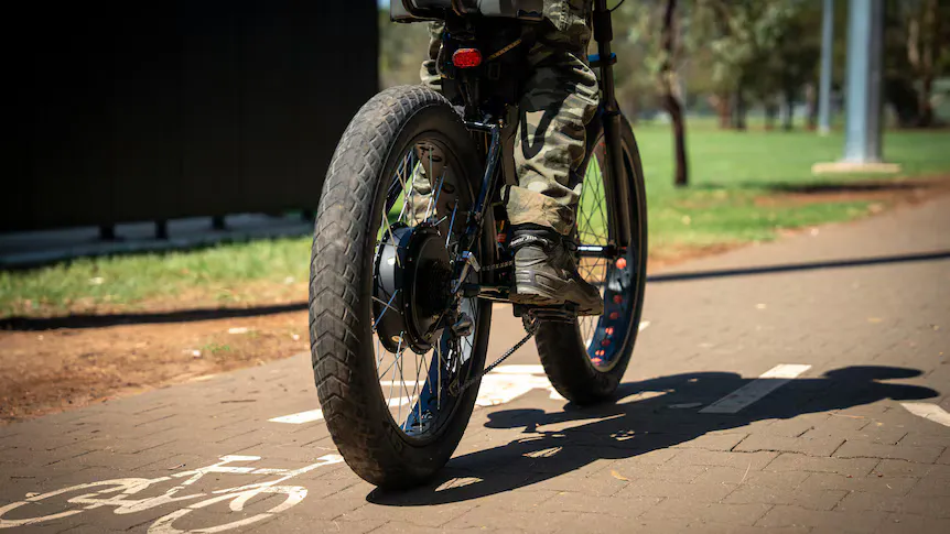 An electric bicycle parked beside a shared path