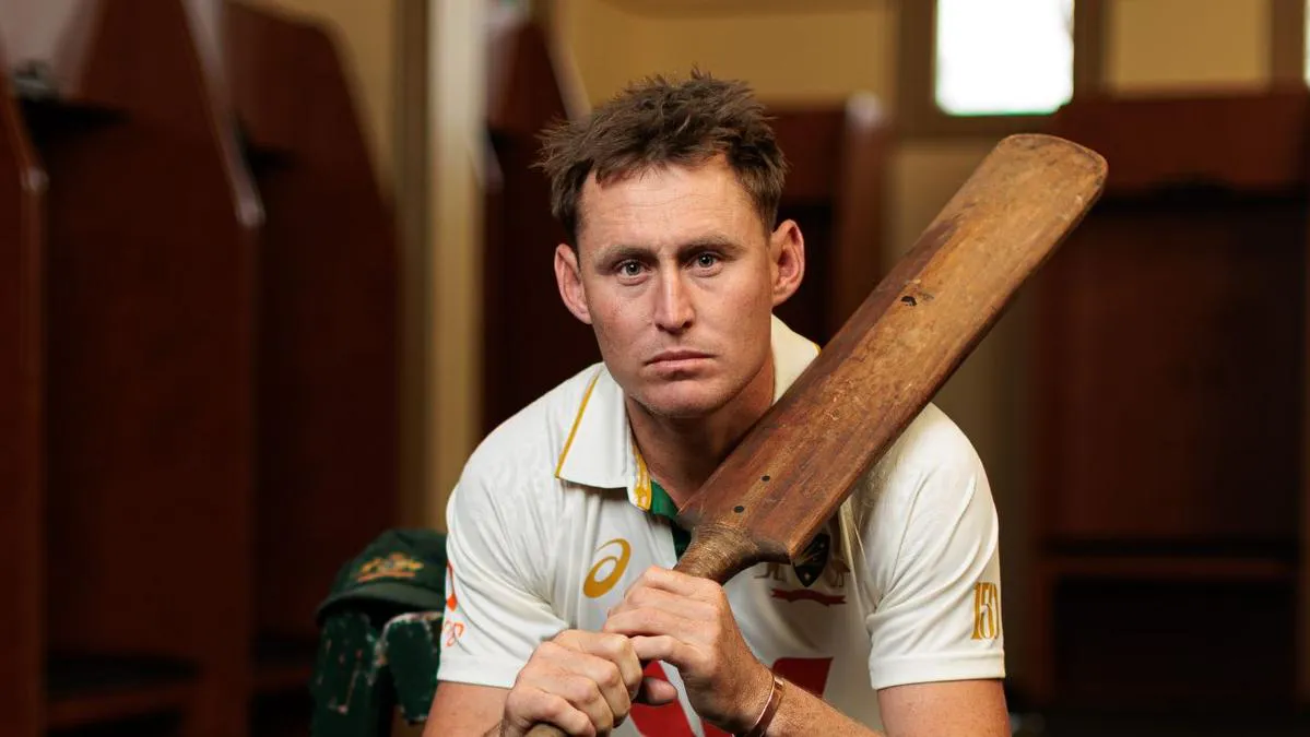 Cricket bat, ball and stumps on a grass field