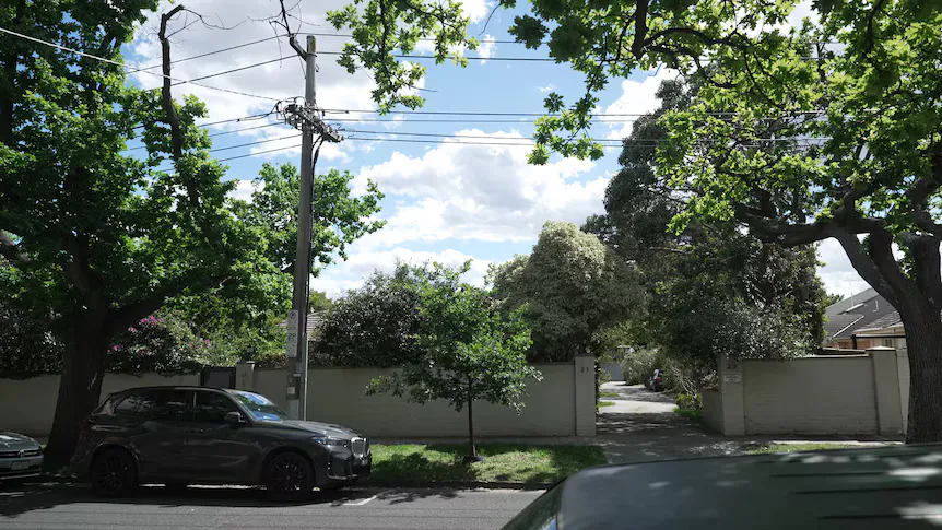 Low-rise homes and apartment buildings along a Melbourne suburban street