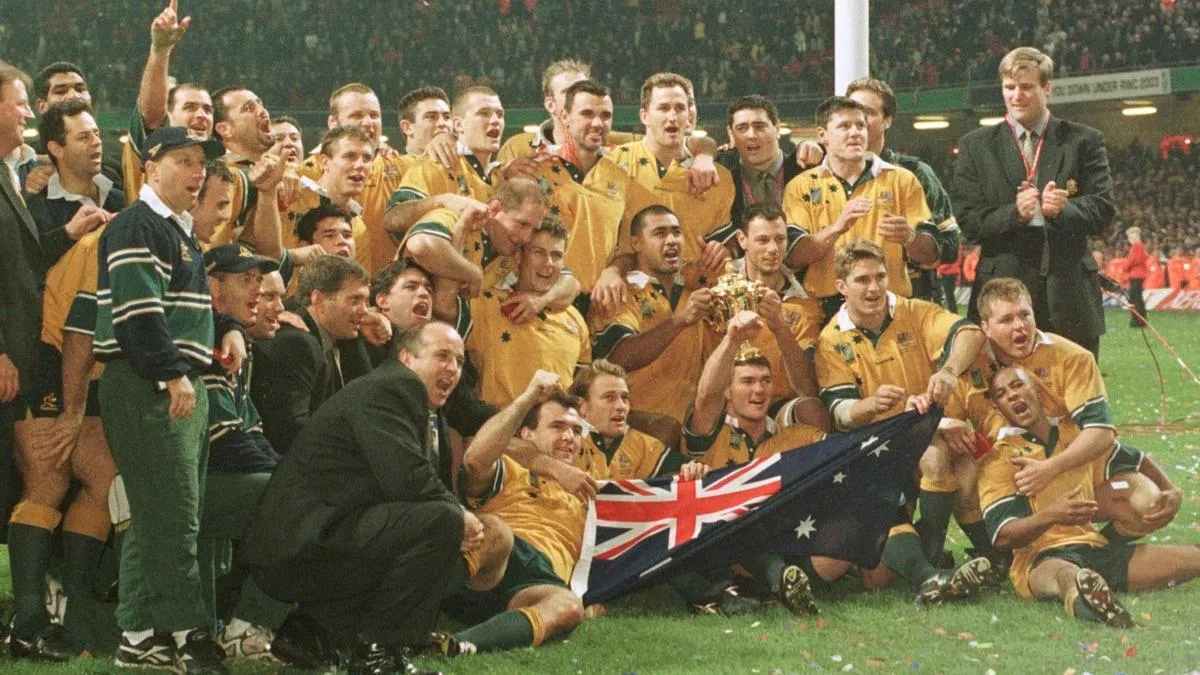 Rugby union ball on grass beside a sideline