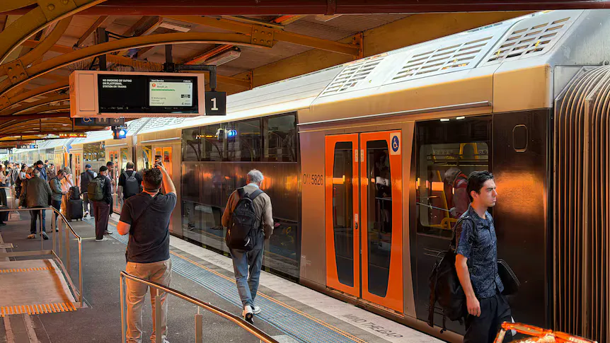 Passenger train beside a suburban railway platform