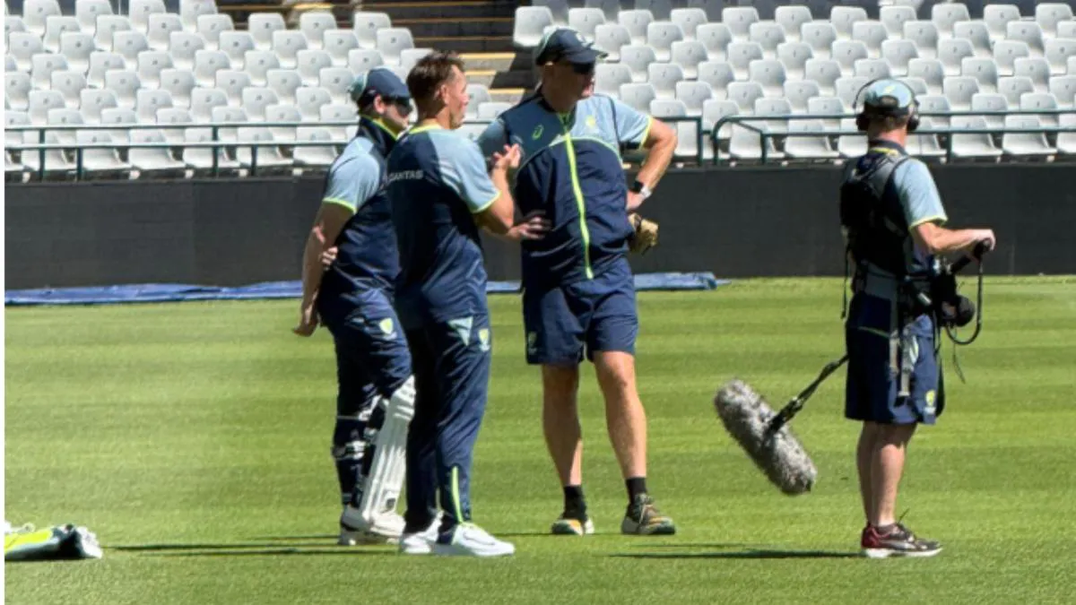 Cricket bats, pads and balls beside practice nets