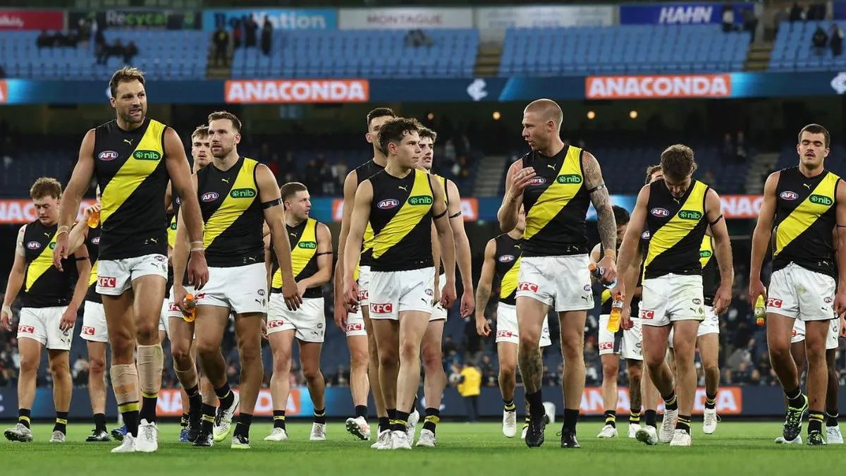 An Australian rules football on grass beside boundary markings