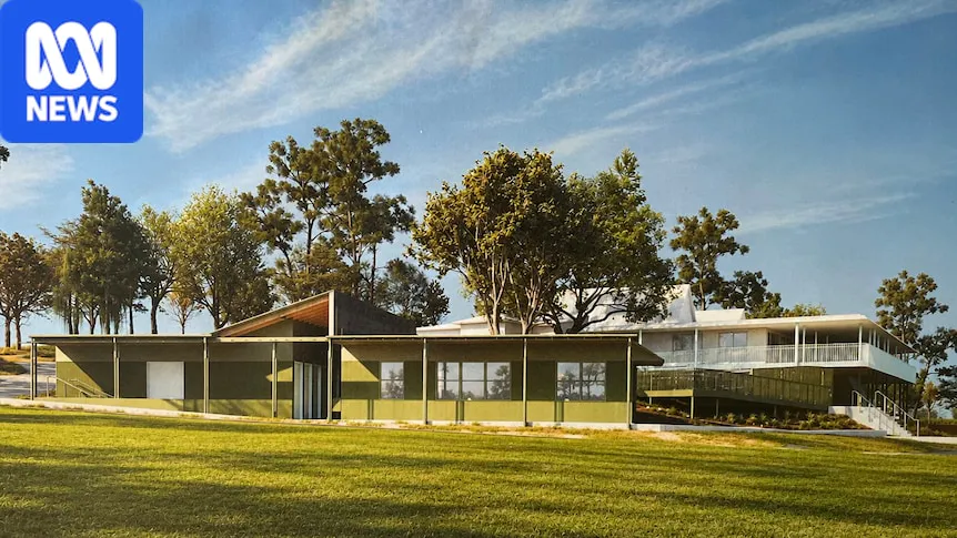 A golf course with a clubhouse beside the fairway