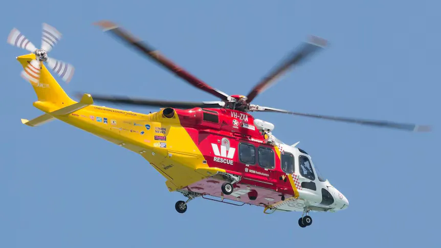 A rescue helicopter parked on a landing pad