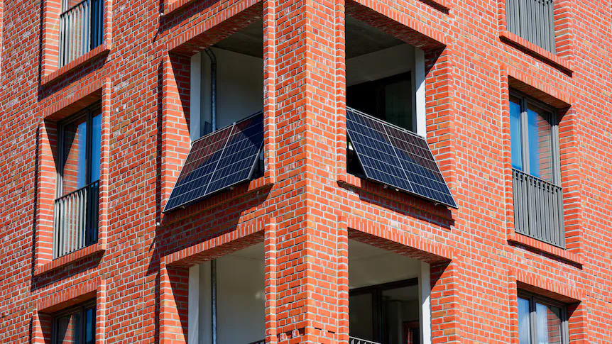 Small solar panels positioned on an apartment balcony