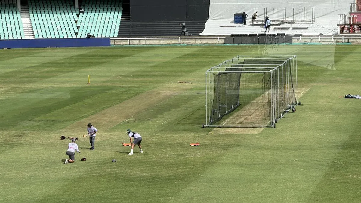 Cricket practice nets beside a ground
