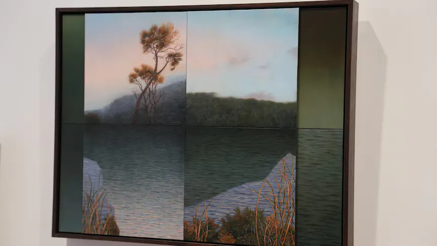 Framed artworks displayed on the walls of a gallery