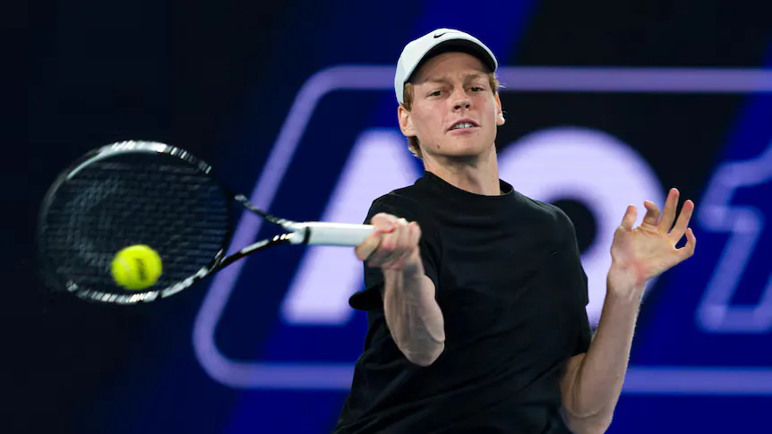 Tennis racquet and ball beside the lines of a hard court