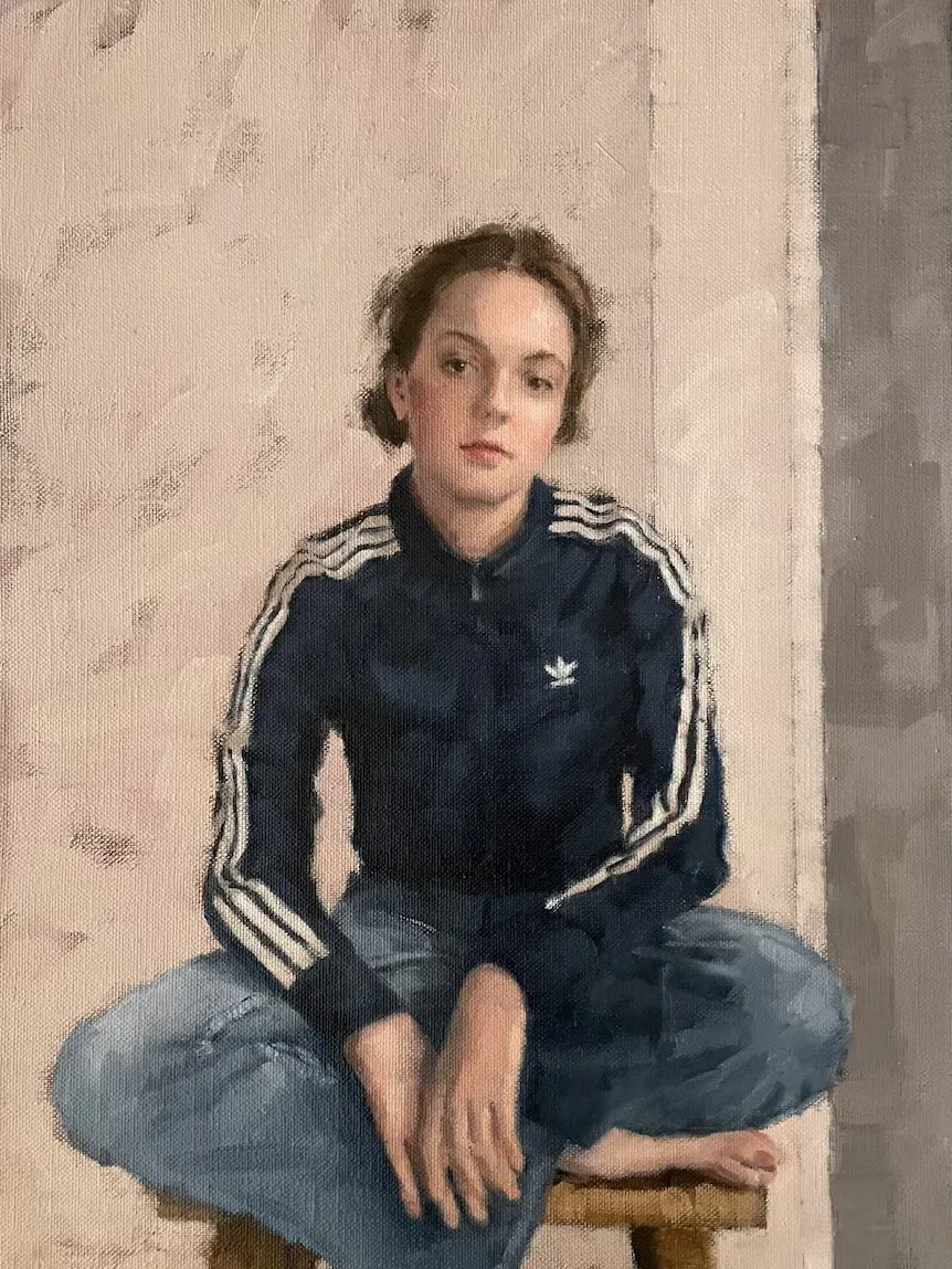 Portrait paintings displayed on the walls of an art gallery