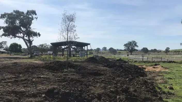 Discarded industrial materials and soil on vacant land