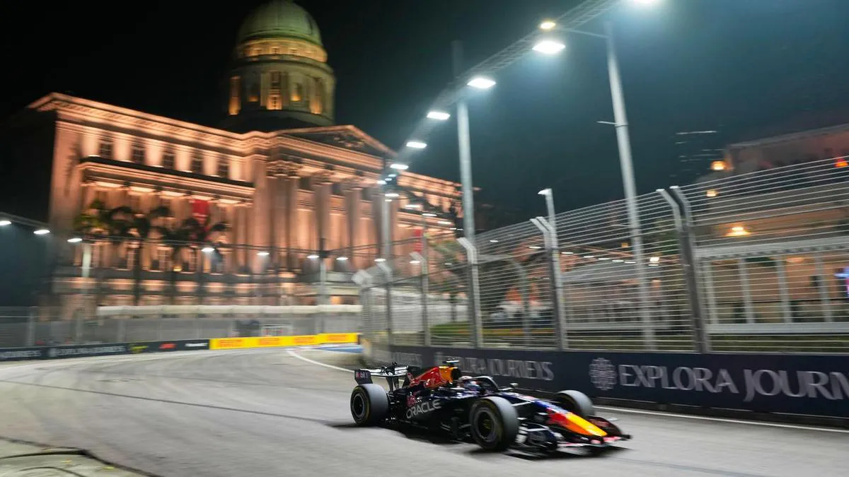 Formula 1 cars on a floodlit street circuit